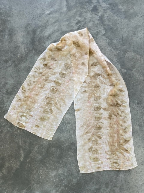 pale pink silk scarf with natural pecan leaf eco print pattern in soft brown color on concrete background
