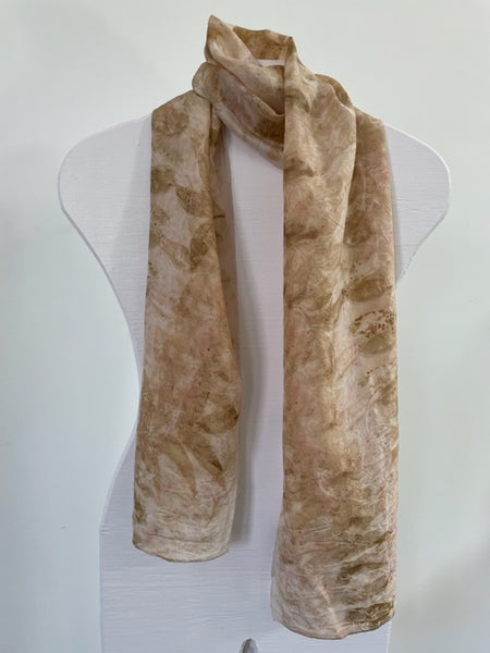 pale pink silk scarf with natural pecan leaf eco print pattern in soft brown color on  white body form neck
