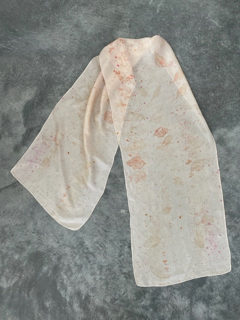 peach blush silk scarf with eco print on concrete ground